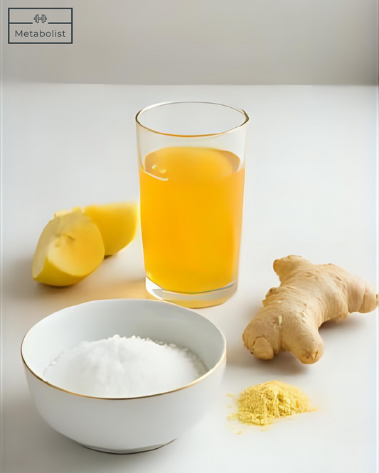Glass of orange juice with lemons, ginger, and salt on a light surface
