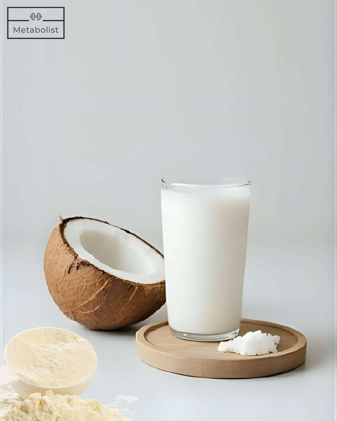Glass of coconut milk with a coconut and Vanilla Powder on a light gray background