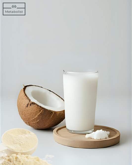 Glass of coconut milk with a coconut and Vanilla Powder on a light gray background