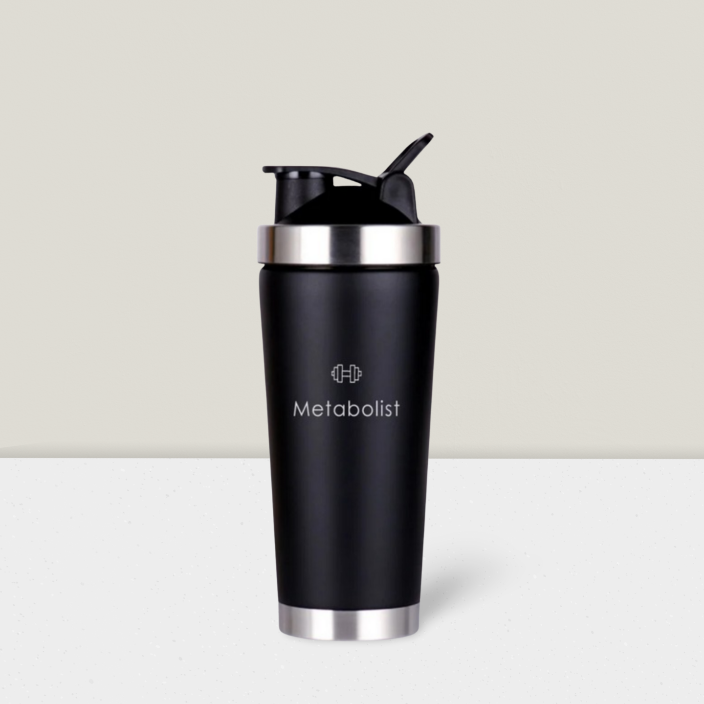 Black shaker bottle with silver lid and 'Metabolist' branding on a light gray background