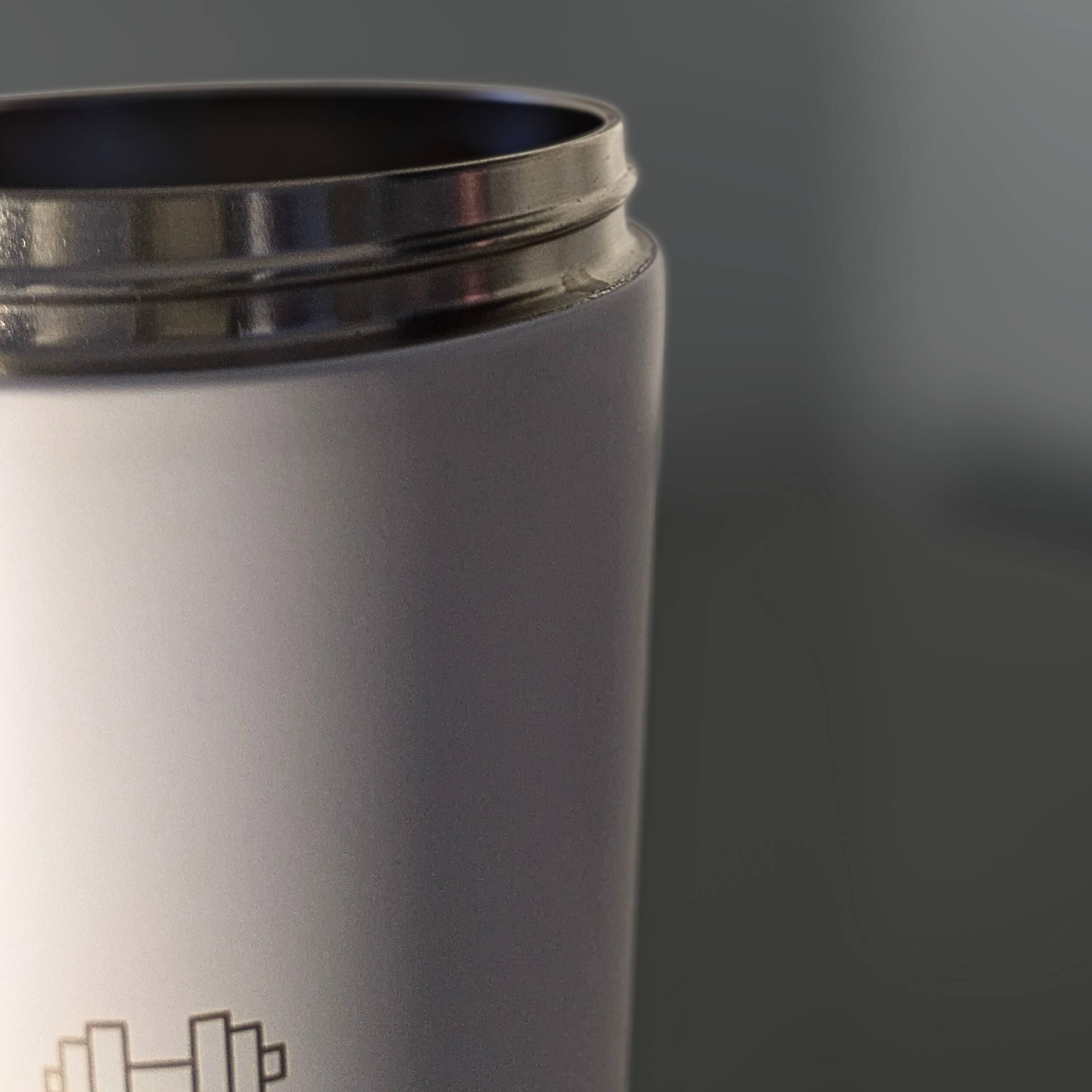 Silver Metabolist Shaker Bottle tumbler with a dark lid on a gray background. Metabolist Premium Stainless Steel Precision Shaker Bottle.
