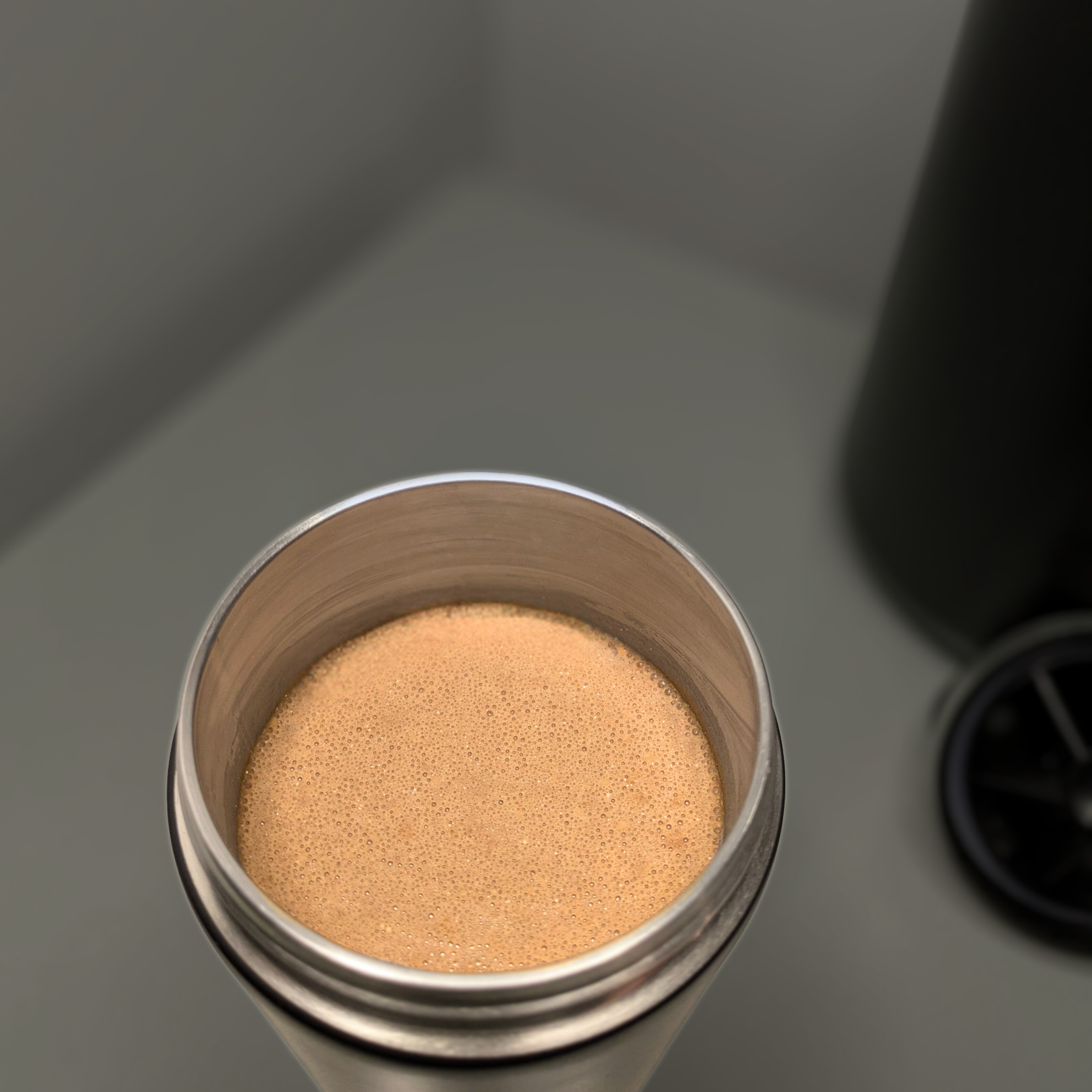 Metabolist Premium Stainless Steel Precision Shaker Bottle with Smoothly mixed chocolate protein shake. 