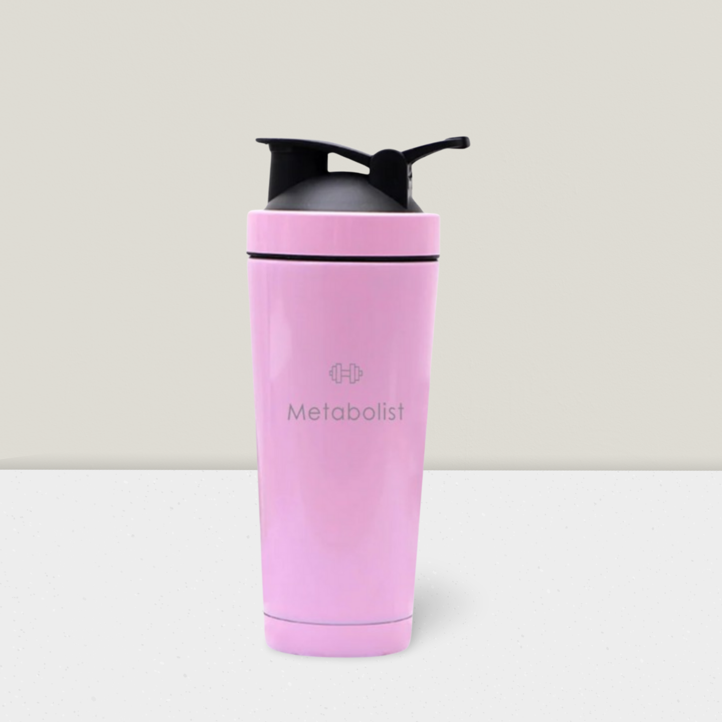 Pink shaker bottle with black cap on a light gray background