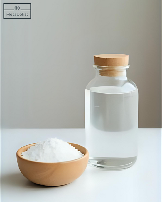Bowl of salt and glass bottle with wooden cap on a light background
