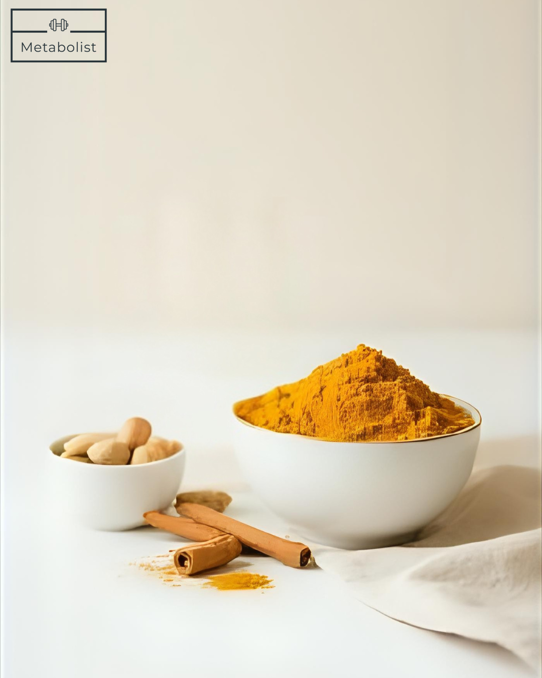Turmeric powder in a white bowl with cinnamon sticks and whole turmeric roots on a light background.