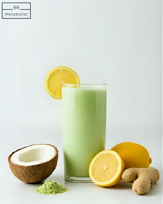Green smoothie with lemons, coconut, and ginger on a white background